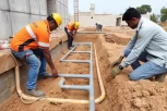 Anti-Termite Reticulation System installation showing underground pipes around building foundation